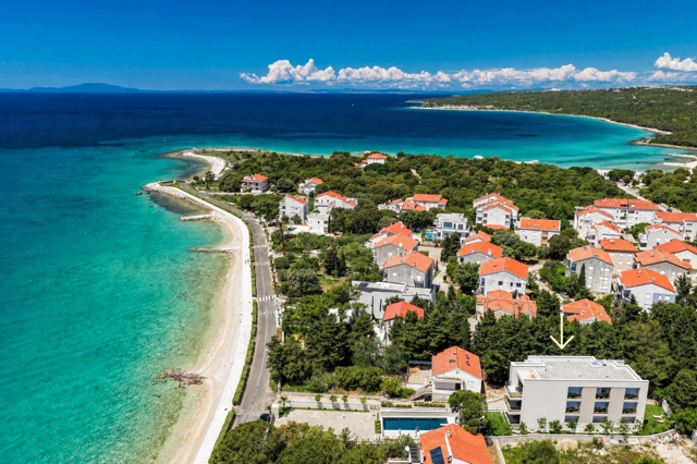 Aerial panorama of Bumblebee apartments near the beach in Novalja, Pag, Croatia with turquoise sea and coastline